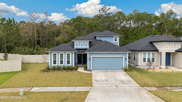 view of front of property featuring a front yard and a garage