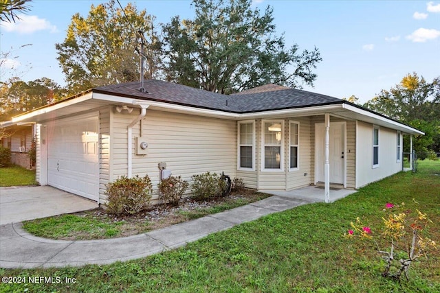 ranch-style home with a front yard and a garage