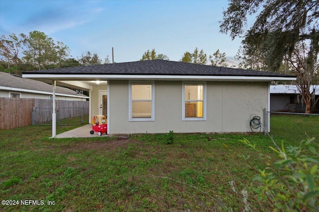 rear view of house with a lawn