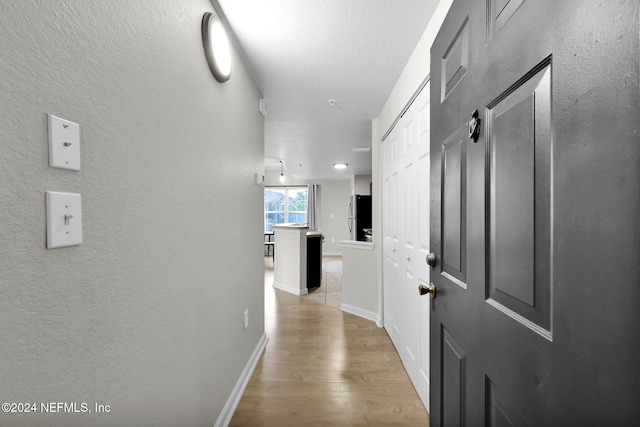 hallway with light wood-type flooring