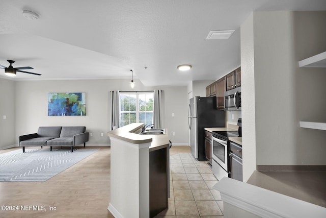 kitchen featuring dark brown cabinets, a textured ceiling, stainless steel appliances, ceiling fan, and sink