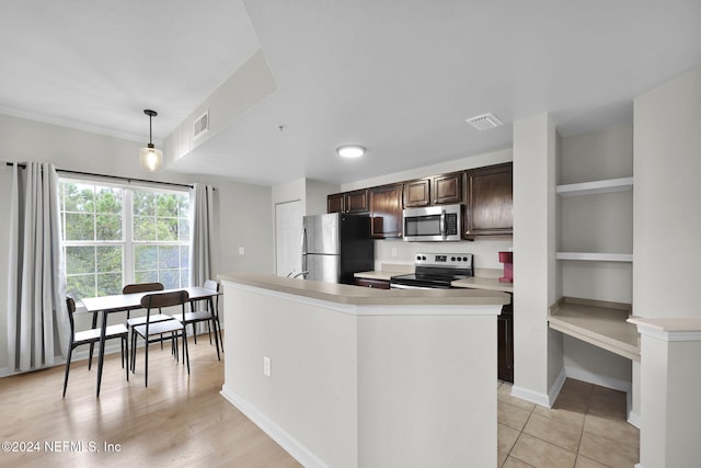 kitchen with pendant lighting, a center island, light hardwood / wood-style flooring, dark brown cabinetry, and stainless steel appliances