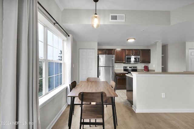 dining area featuring light wood-type flooring