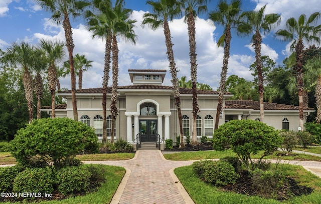 mediterranean / spanish-style house with french doors