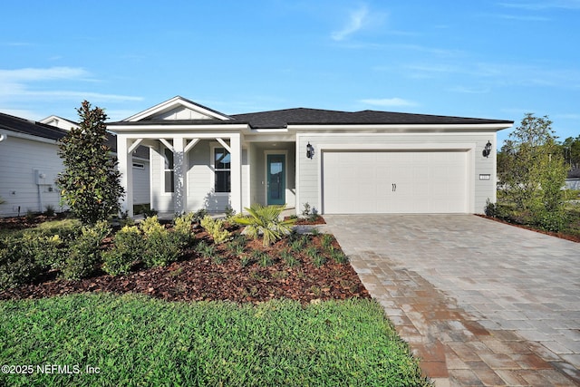 view of front of home featuring decorative driveway and an attached garage