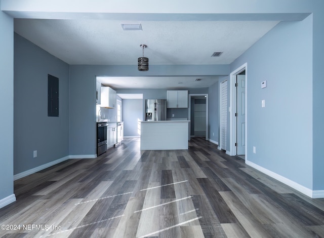 unfurnished living room featuring dark hardwood / wood-style floors and electric panel