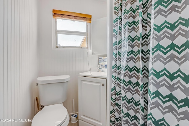 bathroom with vanity, toilet, and walk in shower