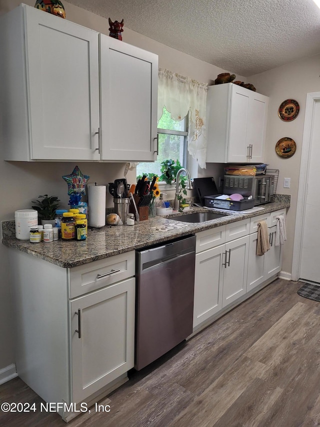 kitchen with a textured ceiling, sink, dishwasher, light hardwood / wood-style floors, and white cabinetry