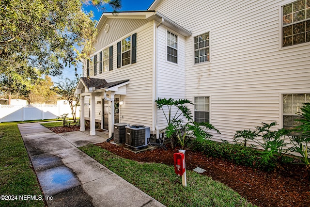 view of side of home with central AC unit