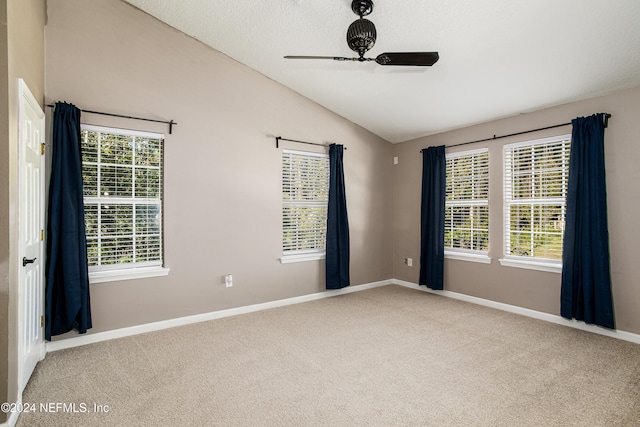 unfurnished room with ceiling fan, carpet floors, and lofted ceiling