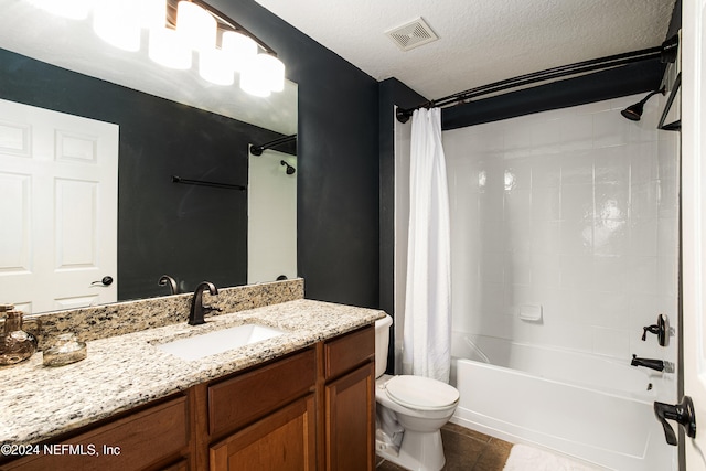 full bathroom featuring tile patterned flooring, a textured ceiling, toilet, shower / tub combo with curtain, and vanity