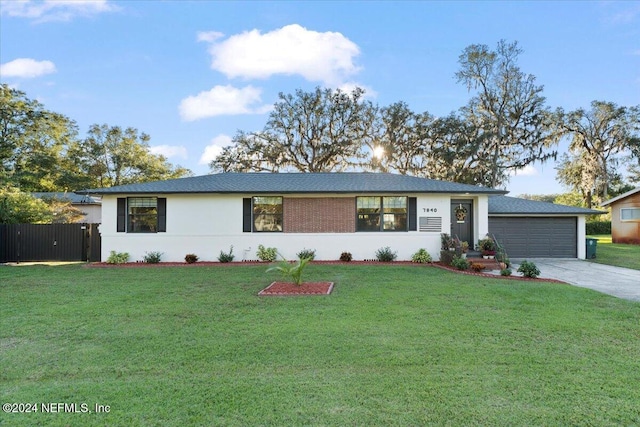 ranch-style home featuring a front yard and a garage