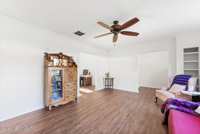 living area with hardwood / wood-style floors, ceiling fan, and ornamental molding