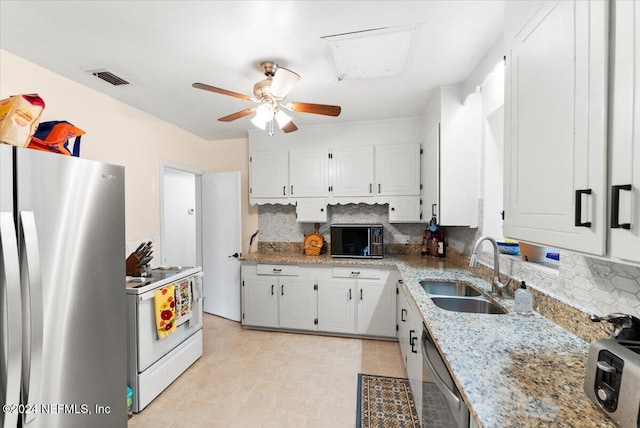 kitchen featuring decorative backsplash, appliances with stainless steel finishes, white cabinetry, and sink