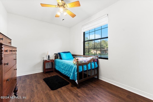 bedroom with ceiling fan and dark hardwood / wood-style flooring