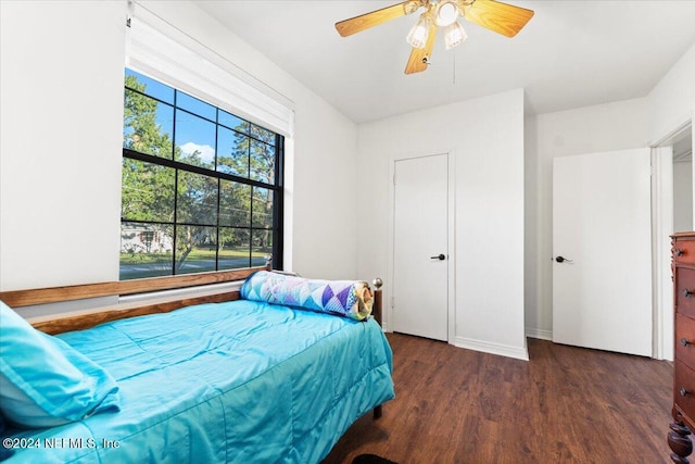 bedroom with ceiling fan and dark hardwood / wood-style floors