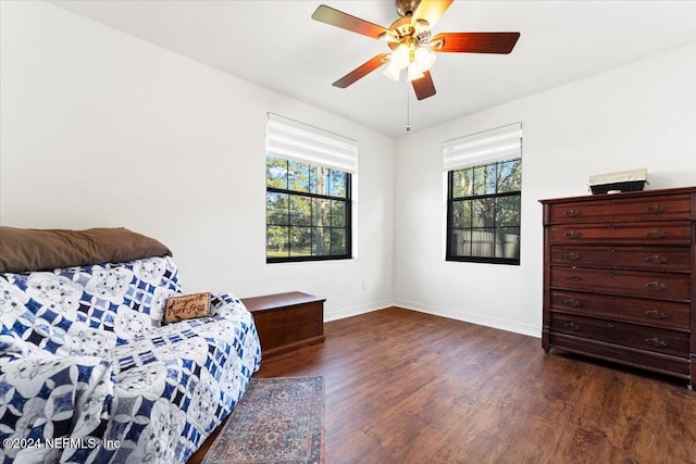 living area featuring ceiling fan and dark hardwood / wood-style floors