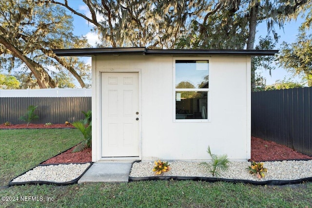 view of outdoor structure with a lawn