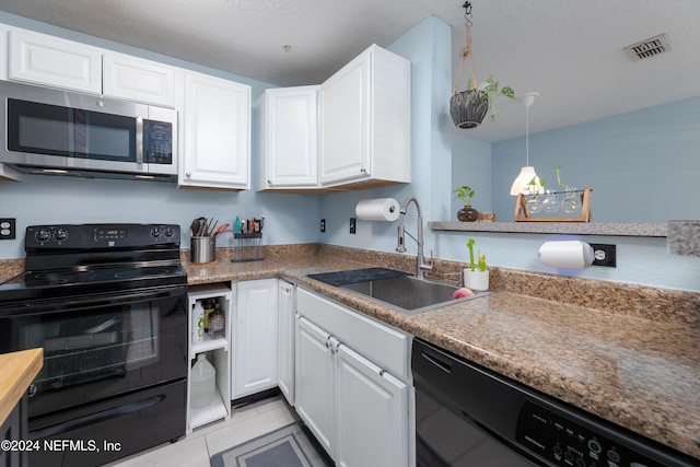 kitchen featuring black appliances, white cabinets, sink, light tile patterned floors, and decorative light fixtures