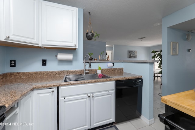 kitchen with white cabinets, kitchen peninsula, and sink