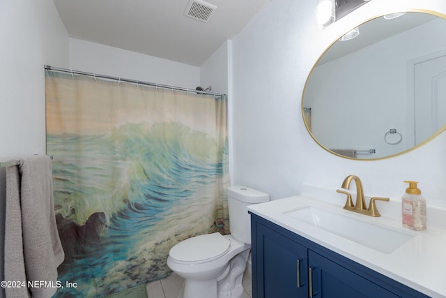 bathroom featuring tile patterned floors, vanity, toilet, and walk in shower