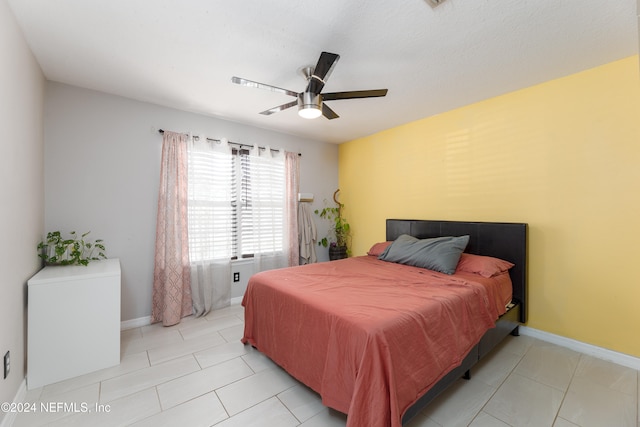 bedroom with ceiling fan and light tile patterned floors