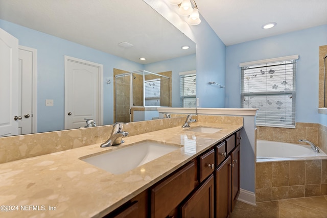 bathroom with tile patterned flooring, vanity, and independent shower and bath