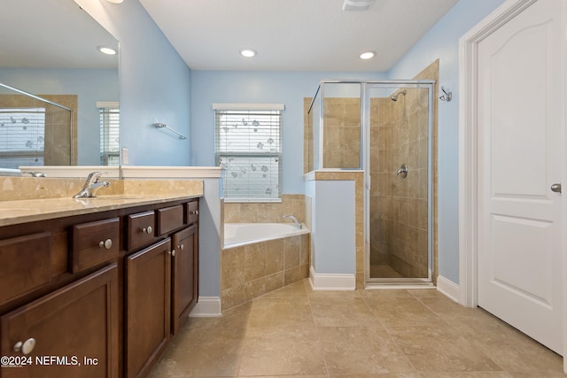 bathroom with tile patterned flooring, vanity, and independent shower and bath