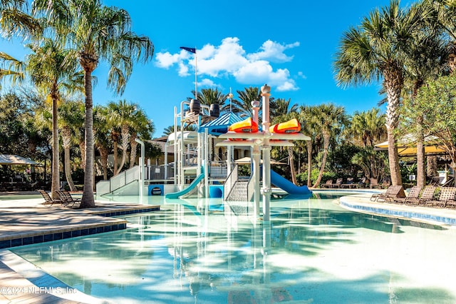 view of swimming pool featuring a playground