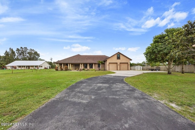 view of front of house featuring a garage and a front lawn