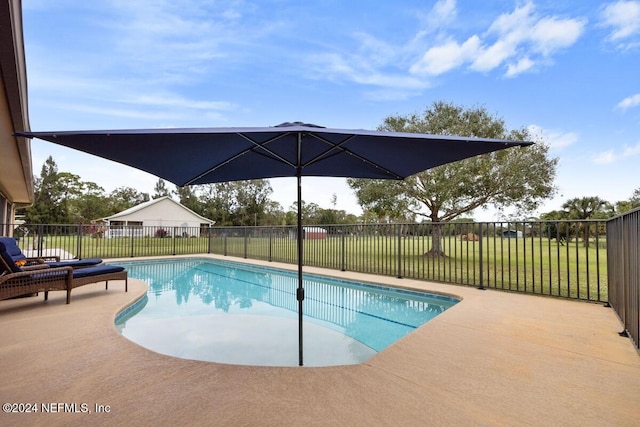 view of swimming pool featuring a patio area and a yard