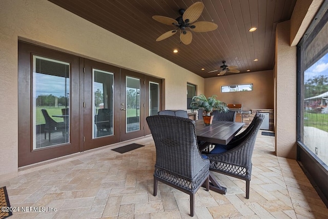 sunroom featuring french doors, ceiling fan, and wood ceiling