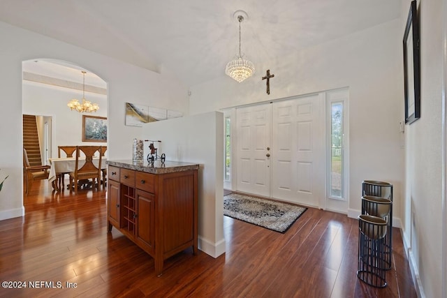 entryway featuring dark hardwood / wood-style floors, an inviting chandelier, and a wealth of natural light