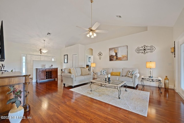 living room with dark hardwood / wood-style floors, ceiling fan, and vaulted ceiling