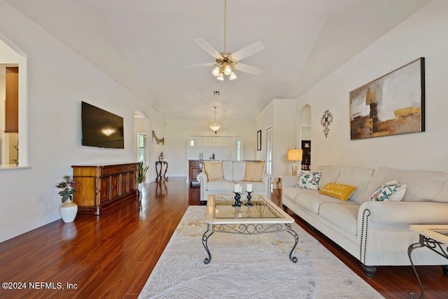 living room with dark hardwood / wood-style flooring and ceiling fan