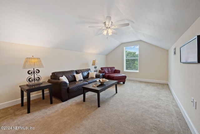 carpeted living room with ceiling fan and vaulted ceiling