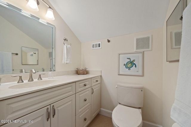 bathroom with vanity, vaulted ceiling, and toilet