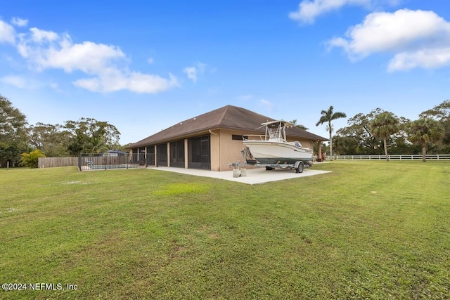 rear view of property with a sunroom and a yard