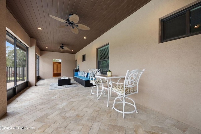 view of patio with outdoor lounge area and ceiling fan