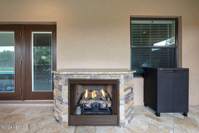 details with an outdoor stone fireplace