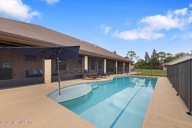 view of swimming pool with a patio area