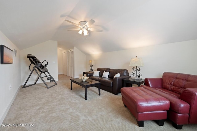 carpeted living room with vaulted ceiling and ceiling fan