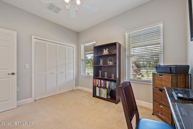 carpeted office featuring ceiling fan