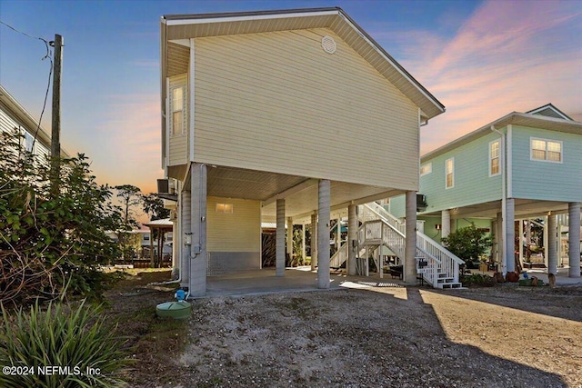 back house at dusk with a carport