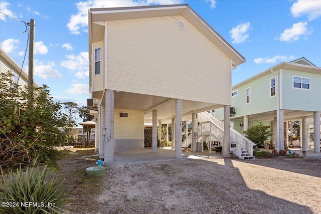 back of property with a carport