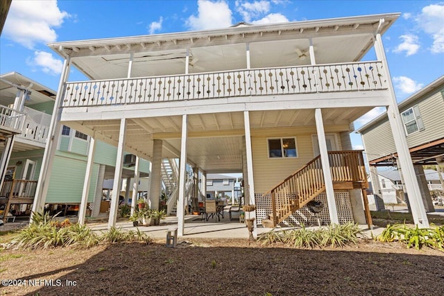 rear view of property with ceiling fan