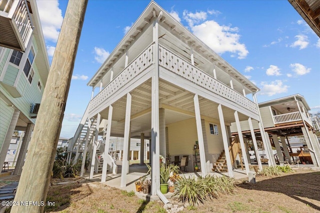 rear view of property featuring a balcony