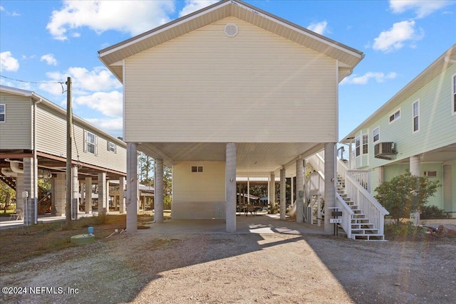 back of house with a carport