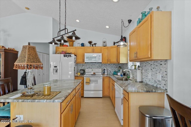 kitchen with lofted ceiling, white appliances, sink, and tasteful backsplash