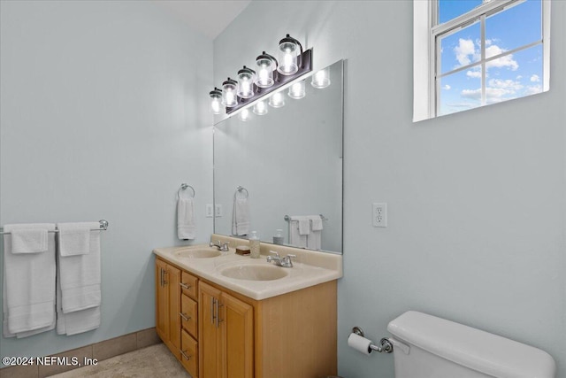 bathroom featuring tile patterned flooring, vanity, and toilet